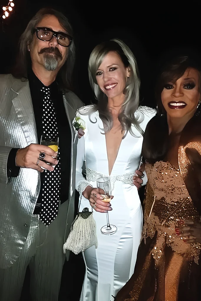 Toni James posing with two people at a formal event
