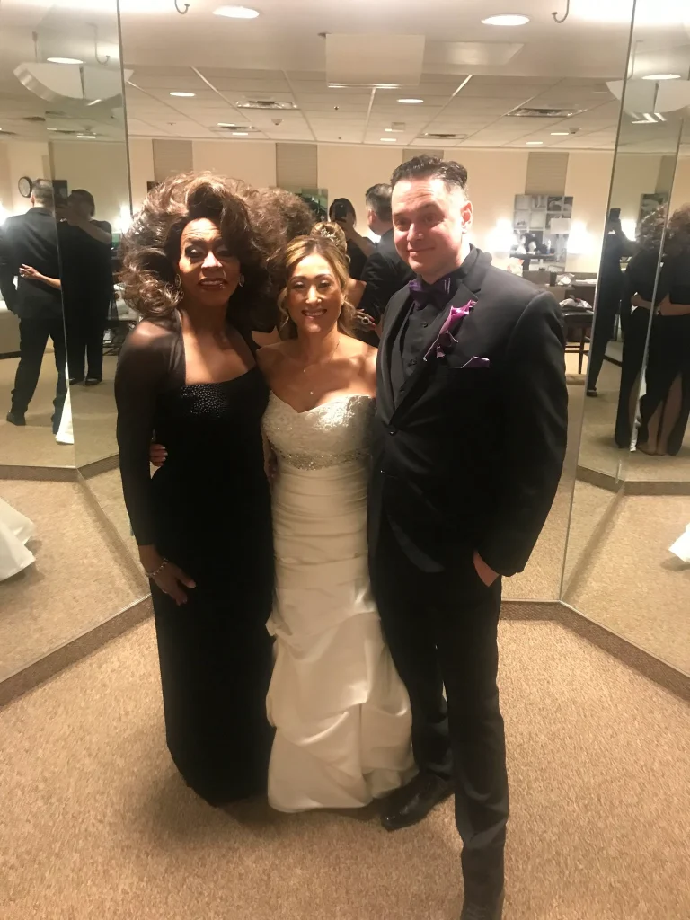 Toni James standing with two people in formalwear